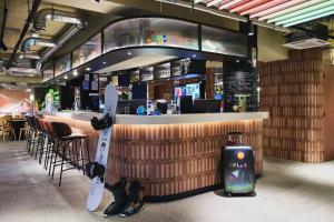a restaurant with a bar with snowboards on display at Moxy Annecy in Annecy