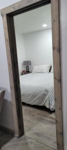 a bedroom with a bed and a large mirror at Greer Point Trails End Cabins in Greer