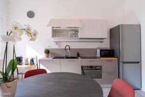 a kitchen with a table and a refrigerator at Varenna My Love in Varenna +31 photos