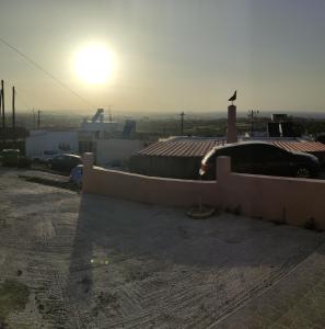 a view of a rooftop with the sun in the background at michaelas traditional house in Fánai