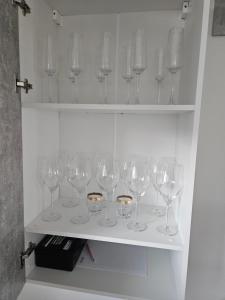 a row of wine glasses sitting on a shelf at FeWo Nahner Loft in Osnabrück