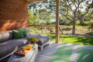 a patio with a couch and a table and a pool at North Harbor Montauk in Montauk