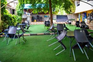 a group of chairs and tables on the grass at Nafelis Hotel Enugu in Enugu