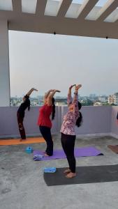 a group of people doing yoga in a room at Yoga Retreat Wellness by Atulyam in Lucknow +6 photos