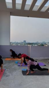 a group of people doing yoga in a room at Yoga Retreat Wellness by Atulyam in Lucknow