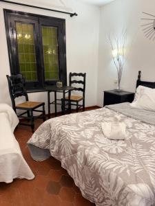 a bedroom with a bed and a table and chairs at el valle hostal restaurante in La Pradera de Navalhorno +8 photos