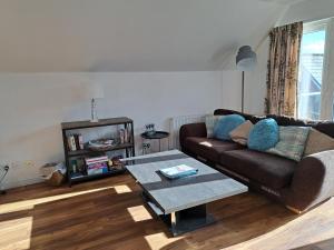 Inchmarlo Golf Resort, Banchory Villa 26 AS 00266F في بانشوري: غرفة معيشة مع أريكة وطاولة قهوة