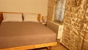Postel nebo postele na pokoji v ubytování To Portoni Guesthouse