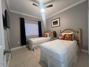 a bedroom with two beds and a ceiling fan at Homestead Green retreat in Homestead