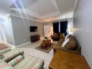 a living room with a couch and a table at Homestead Green retreat in Homestead