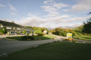 a winding road in front of a house at Town & Country Inn & Resort in Gorham