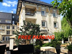a building with a free parking sign in front of it at Eney Boutique Hotel in Lviv