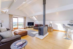 a living room with a fireplace and a couch at Cobstone Cottage in Walmersley
