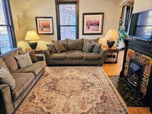 a living room with a couch and a fireplace at Cathedral Hill Charm in Saint Paul