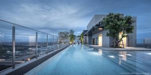 a swimming pool on the roof of a building at One bedroom condo with rooftop pool in Ban Talat Rangsit