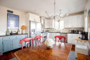 a kitchen with a wooden table and red chairs at Best hotel alternative for big group near train to NYC in Greenwich