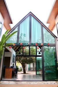 a large glass building with a tree inside of it at Chic Villa 6 in Chiang Mai