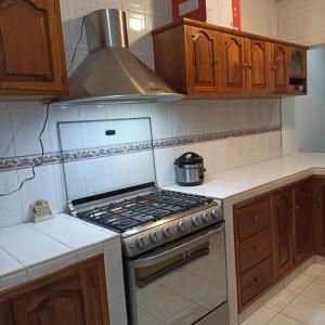 a kitchen with a stove top oven in a kitchen at Casa ISA in Cancún