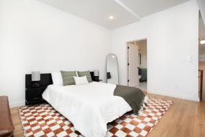 a bedroom with a large bed and a checkered rug at Modern Cityscape Downtown Knoxville in Knoxville