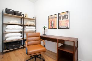 a office with a desk and a chair and a shelf at Modern Cityscape Downtown Knoxville in Knoxville