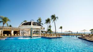 a pool at a resort with a water fountain at Pierre Mundo Imperial Riviera Diamante Acapulco All Inclusive in Acapulco