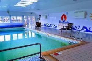 a large swimming pool in a building at No 38 Heilan Hoose at Three Lochs Newton Stewart in Newton Stewart
