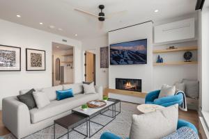 a living room with a couch and a fireplace at Electric Pass Lodge by Snowmass Vacations in Snowmass Village
