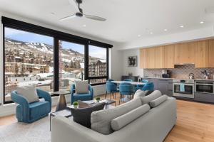 a kitchen and living room with a couch and chairs at Electric Pass Lodge by Snowmass Vacations in Snowmass Village