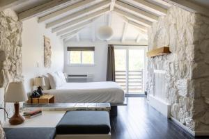 a bedroom with a bed and a stone wall at Scribner's Catskill Lodge, a Member of Design Hotels in Hunter