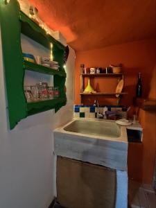 a kitchen with a sink and a green shelf at La Casita de Sandra in Paulenca +26 photos