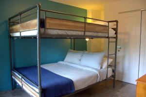 a bedroom with two bunk beds with white pillows at Le Chalet Beatrice & Spa in Sainte Béatrix +70 photos