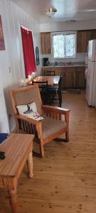 a living room with a bench and a table and a kitchen at Greer Point Trails End Cabins in Greer