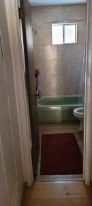 a bathroom with a tub and a toilet and a sink at Greer Point Trails End Cabins in Greer