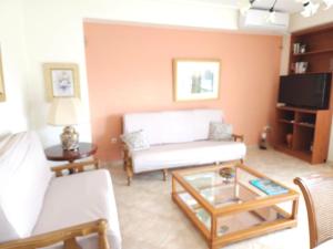 a living room with a couch and a coffee table at Garbo Appartments in Karistos