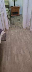 a room with a wooden floor and a table at Greer Point Trails End Cabins in Greer
