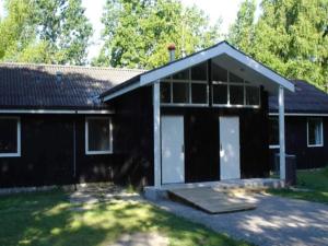 a black and white house with a garage at 2 person Holiday Home in Læsø in Læsø