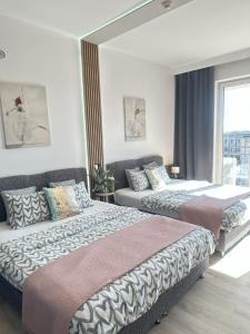 Posteľ alebo postele v izbe v ubytovaní Exclusive Apartments Smolna