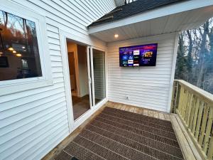 a porch with a television on the side of a house at 2 Bedroom Apartment in SONO! in Norwalk