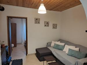 a living room with a couch and a table at Messonghi- La Pazzeli in Káto Spílaion