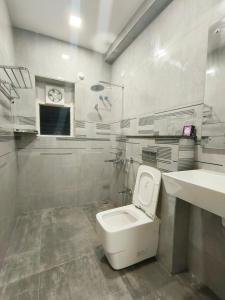 a bathroom with a white toilet and a sink at Just Launched Ultra Modern 4BHK Duplex Fully Furnished Between JNTU Metro & Miyapur Metro in Hyderabad +44 photos