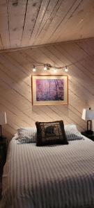 a bedroom with a bed with a picture on the wall at Greer Point Trails End Cabins in Greer
