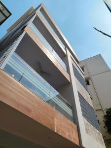 a building with large windows on the side of it at Just Launched Ultra Modern 4BHK Duplex Fully Furnished Between JNTU Metro & Miyapur Metro in Hyderabad