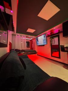 a living room with red lighting and a couch at C12 Deluxe in Cap d'Agde