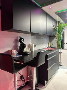 a kitchen with black and white cabinets and a counter at C12 Deluxe in Cap d'Agde