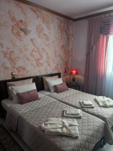 a bedroom with two beds with towels on them at Country Escape in Volos +10 photos