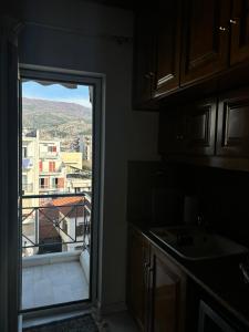 a kitchen with a view of a city from a window at Country Escape in Volos +10 photos