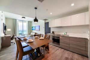 a kitchen and dining room with a table and chairs at Direct Ocean view Condo Steps from the Beach in Hollywood