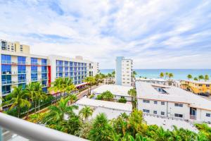 a view of the beach from the balcony of a resort at Direct Ocean view Condo Steps from the Beach in Hollywood