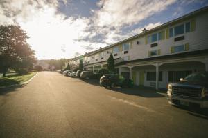 a street with cars parked next to a building at Town & Country Inn & Resort in Gorham