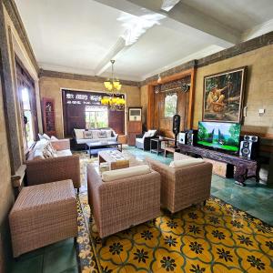 a living room with couches and a flat screen tv at Villa Djojonagoro in Ketewel